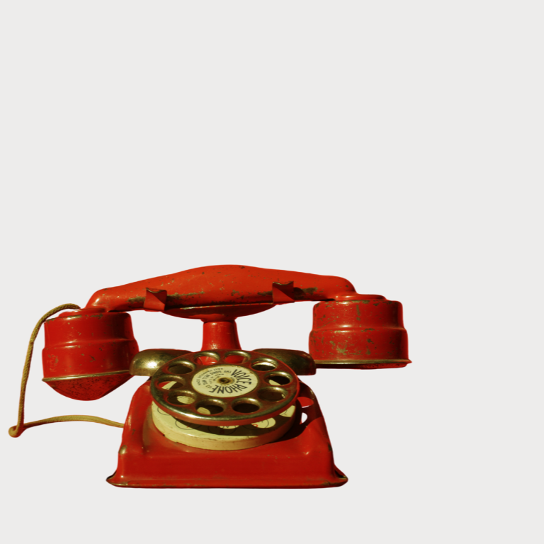 Red vintage telephone on a white background