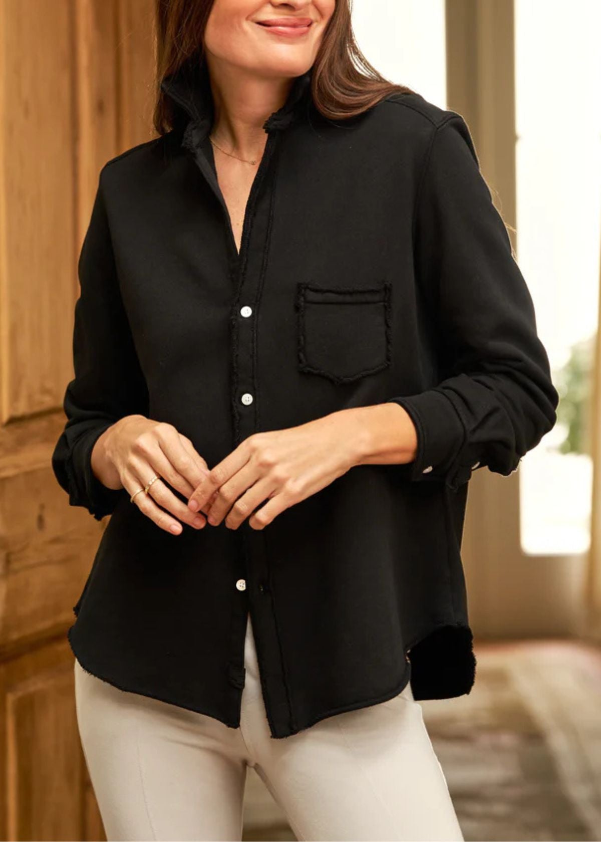 Woman wearing a black shirt with a blurred background