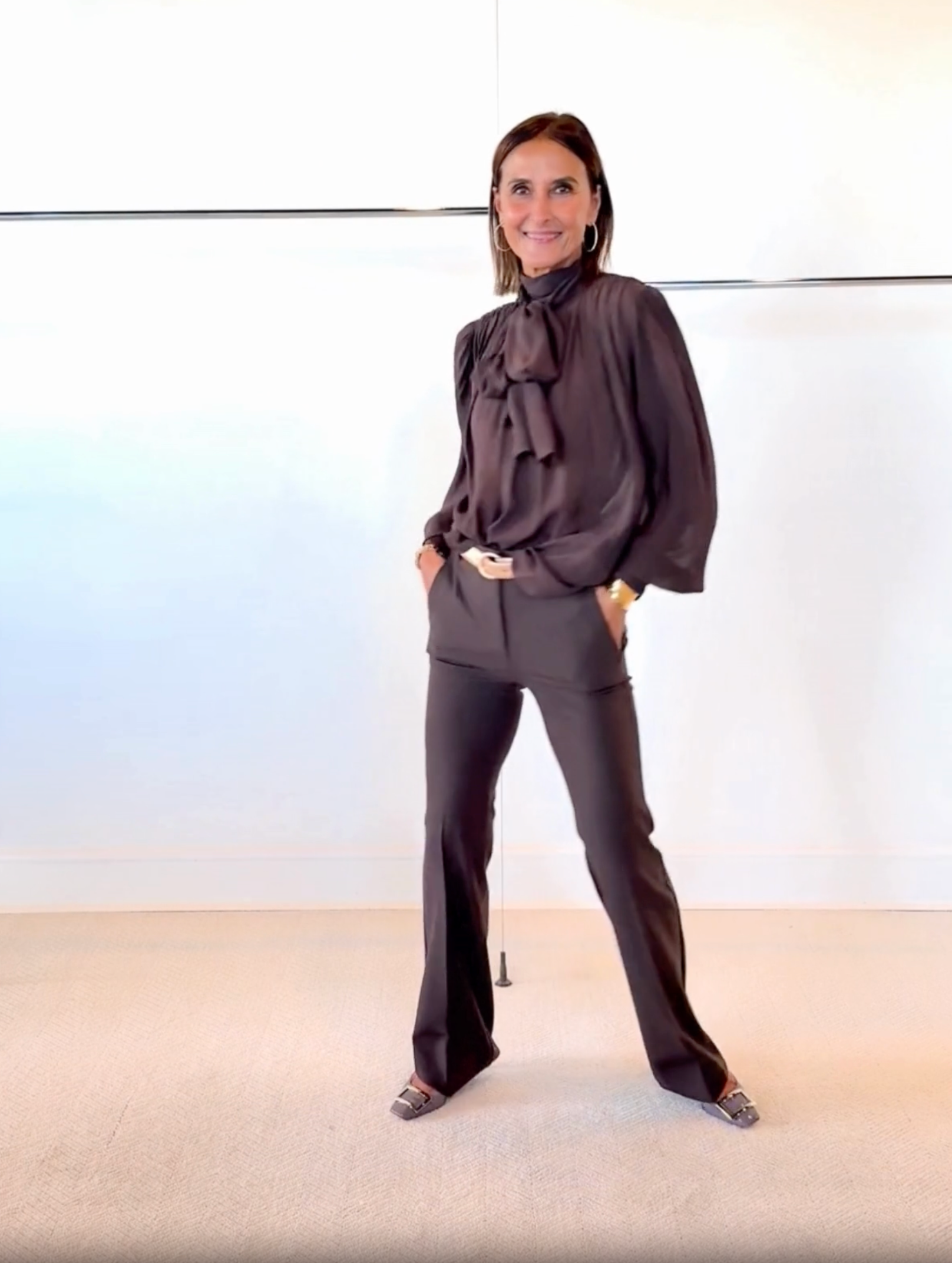 woman wearing brown pants and a brown blouse